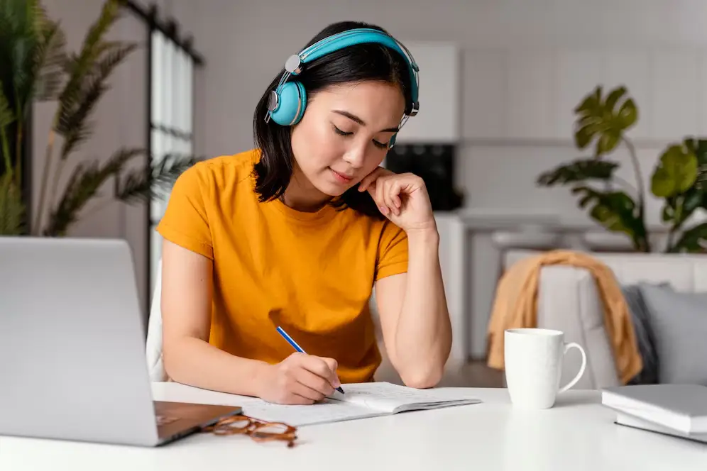 Femme suivant un cours en ligne sur son ordinateur portable, engagée dans son apprentissage à distance